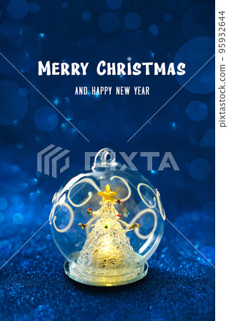 Glass ball with a glowing Christmas tree inside Glass ball with a glowing Christmas tree inside 95932644