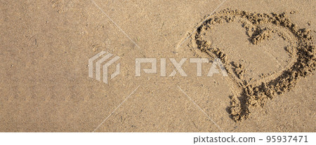 A heart drawn in the sand. Beach background. Top view, space for text A heart drawn in the sand. Beach background. Top view, space for text 95937471