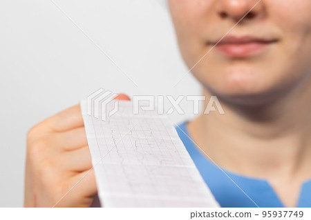 The cardiologist shows the film of an electrocardiogram of a patient with acute myocardial infarction The cardiologist shows the film of an electrocardiogram of a patient with acute myocardial infarction 95937749