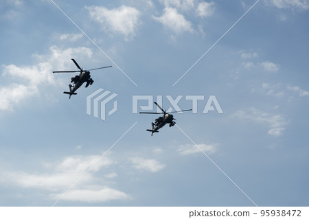 Boeing AH-64 attack helicopters on formation during an air show. Greek Air Force Apache flying on Thessaloniki, Greece during the 28 October National Oxi Day parade. 95938472