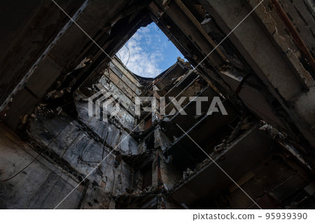 inside a destroyed house with floors fallen from an aerial bomb 95939390