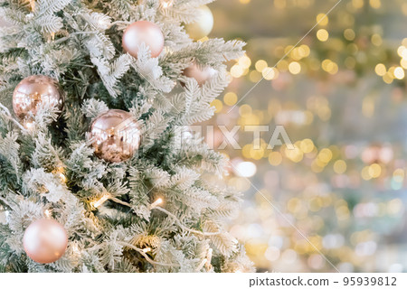 Christmas tree decorated with golden balls. Merry christmas card. New Year decoration on bokeh backdrop. Copy space. Christmas tree decorated with golden balls. Merry christmas card. New Year decoration on bokeh backdrop. Copy space. 95939812
