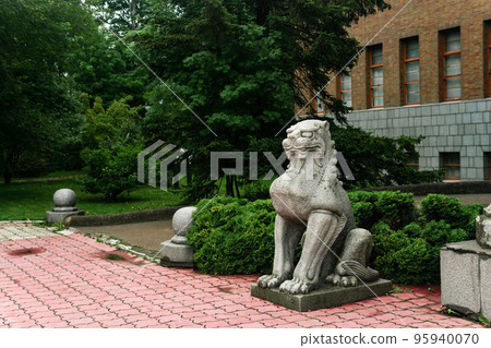 traditional Japanese statue of a stone lion at the entrance to the Sakhalin Museum of Local Lore 95940070