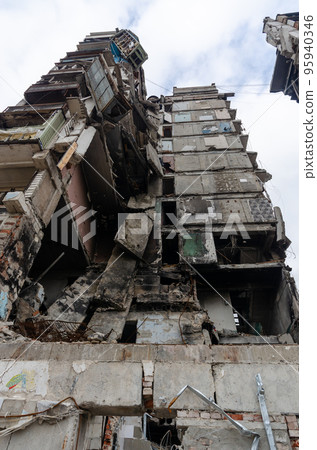 destroyed and burned houses in the city during the war in Ukraine 95940346