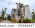 destroyed and burned houses in the city during the war in Ukraine 95940447