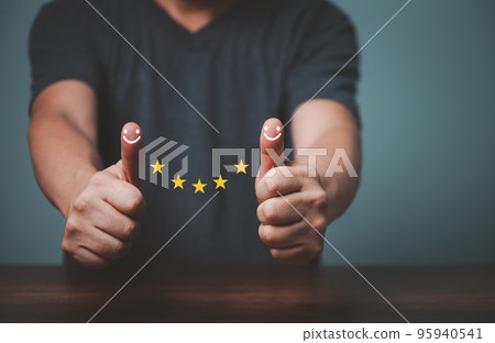 Businessman raised thumps up and give satisfaction five stars rating, sign of the top service, customer good service. Businessman raised thumps up and give satisfaction five stars rating, sign of the top service, customer good service. 95940541