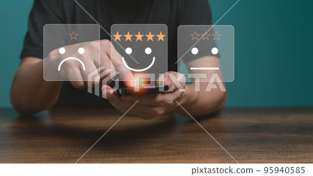 Customer service and Satisfaction concept ,Business people are touching the virtual screen on the happy Smiling face icon to give satisfaction in service. rating very impressed. Customer service and Satisfaction concept ,Business people are touching the virtual screen on the happy Smiling face icon to give satisfaction in service. rating very impressed. 95940585
