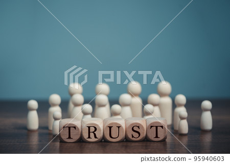 Wooden blocks with the word Trust, Trust relationships between, reliable partner, business partners, confidence person, friends, relatives, respect and authority. 95940603