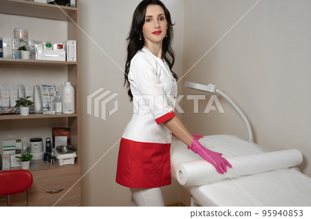 Portrait of a cosmetologist near the couch for procedures, Portrait of a cosmetologist near the couch for procedures, 95940853