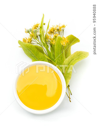 Linden honey in white bowl and wooden dipper isolated on white background 95940888