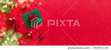 Christmas letter with greeting card and congratulations, christmas tree branches, baubles, glitter decorations on red. Merry Christmas happy New Year concept. Flat lay, banner, copy space 95941134