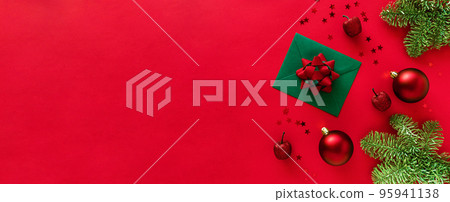 Christmas letter with greeting card and congratulations, christmas tree branches, baubles, glitter decorations on red surface. Merry Christmas happy New Year concept. Flat lay, copy space 95941138