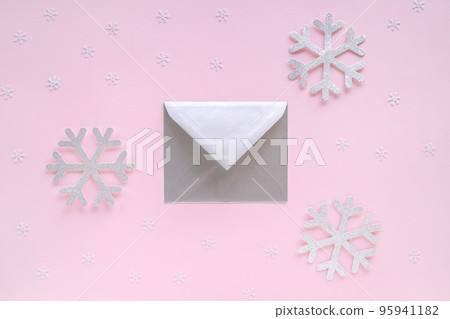 Silver envelope with greeting card and snowflakes on pastel pink background. Letter with congratulations, letter to Santa Claus. Christmas or New Year 2021 minimal concept. Silver envelope with greeting card and snowflakes on pastel pink background. Letter with congratulations, letter to Santa Claus. Christmas or New Year 2021 minimal concept. 95941182