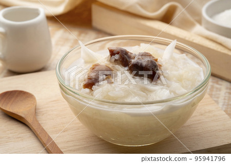 Sweet Sticky Rice with dry Longan and sliced young Coconut topping with coconut cream ,Khao niew piak lam yai (Thai Dessert) 95941796