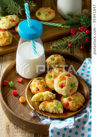 Baked Christmas cookies. Homemade Chip Cookies with Zest and Candied Fruit on a wooden table. Baked Christmas cookies. Homemade Chip Cookies with Zest and Candied Fruit on a wooden table. 95941847
