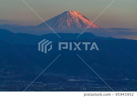 Yamanashi / Red Mt.Fuji and the town of Kofu dyed in the evening sun 95943952