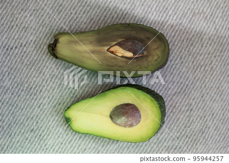 Half the spoiled and good avocado. Comparison of opposites. Half the spoiled and good avocado. Comparison of opposites. 95944257