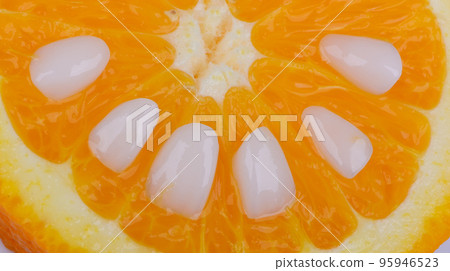 Close-up super thin porcelain laminated white veneers lying down on a piece of orange. Close-up super thin porcelain laminated white veneers lying down on a piece of orange. 95946523
