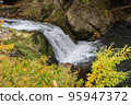 yellow autumn leaves and waterfall 95947372