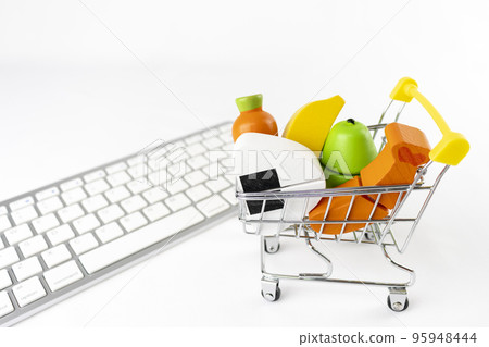 Shopping cart and wooden toy food and keyboard. Image of shopping at an online supermarket 95948444