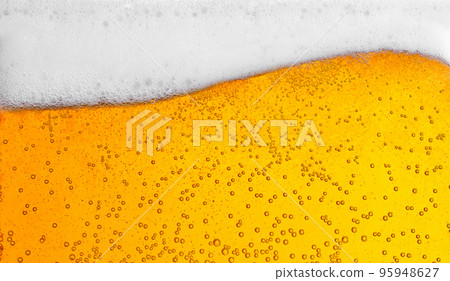 pouring beer with bubbles for background and wave shape texture foam 95948627