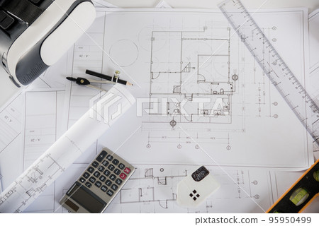 Architectural blueprint paper project plans on desk table, tool for engineer contractor building interior design drawing and VR glasses, industry virtual technology, Architect workplace concept 95950499