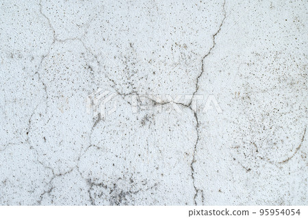 Old concrete stone wall covered with cracked plaster and dirty grunge textured surface. Old concrete stone wall covered with cracked plaster and dirty grunge textured surface. 95954054