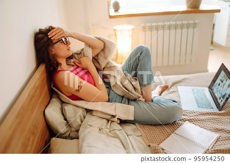 Woman blogger videotapes her vlog at home and speaking about Vaccine for covid-19. Woman blogger videotapes her vlog at home and speaking about Vaccine for covid-19. 95954250