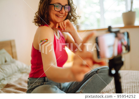 Woman blogger videotapes her vlog at home and speaking about Vaccine for covid-19. 95954252
