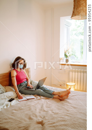 Woman blogger videotapes her vlog at home and speaking about Vaccine for covid-19. Woman blogger videotapes her vlog at home and speaking about Vaccine for covid-19. 95954255