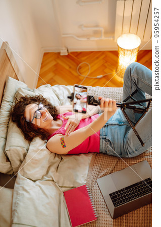 Woman blogger videotapes her vlog at home and speaking about Vaccine for covid-19. 95954257