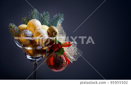 Christmas balls in wineglass . Christmas balls in wineglass . 95955502