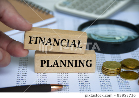 Financial planning text on wooden blocks with office table background. Business planning concept. Financial planning text on wooden blocks with office table background. Business planning concept. 95955736