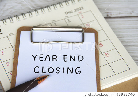 Year end closing text on white notepad with December calendar background. business closing concept. Year end closing text on white notepad with December calendar background. business closing concept. 95955740