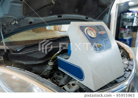 Automated change of brake fluid in a car service. Car bonnet. 95955963