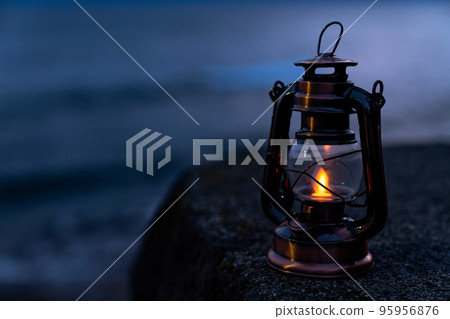 Antique lantern placed near the sea 95956876
