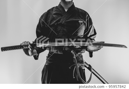 A person holding a Japanese sword 95957842