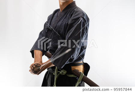A person holding a Japanese sword A person holding a Japanese sword 95957844