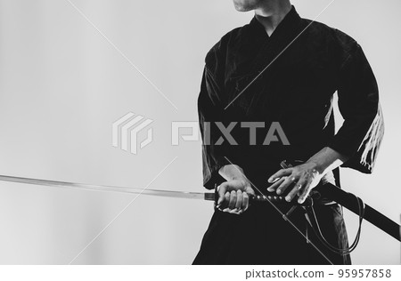 A person holding a Japanese sword A person holding a Japanese sword 95957858