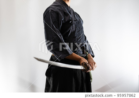 A person holding a Japanese sword 95957862