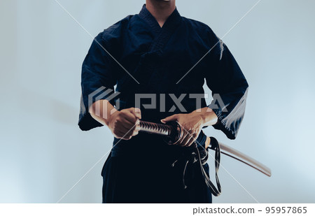A person holding a Japanese sword 95957865
