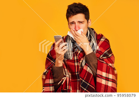 Picture from a young man with handkerchief. I am sick. plaid wrapped himself. studio shot. Picture from a young man with handkerchief. I am sick. plaid wrapped himself. studio shot. 95958079