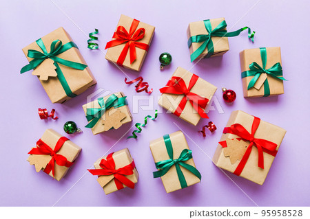 Colored craft gift boxes with colorful ribbons on colored background. Collection of Christmas present boxes Colored craft gift boxes with colorful ribbons on colored background. Collection of Christmas present boxes 95958528