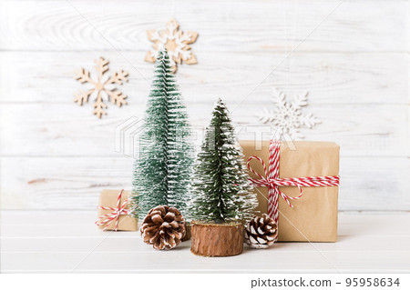 Christmas composition. Gifts, small tree, branches and craft DIY decorations on white background. New year concept. Christmas home decoration Flat lay, top view, copy space Christmas composition. Gifts, small tree, branches and craft DIY decorations on white background. New year concept. Christmas home decoration Flat lay, top view, copy space 95958634