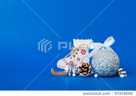 Christmas ball with skates on colored background. decoration bauble with ribbon bow with copy space Christmas ball with skates on colored background. decoration bauble with ribbon bow with copy space 95958666