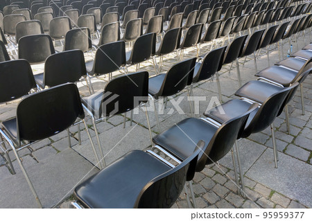 Empty chairs in front of the stage. Preparing for the concert. Empty chairs in front of the stage. Preparing for the concert. 95959377