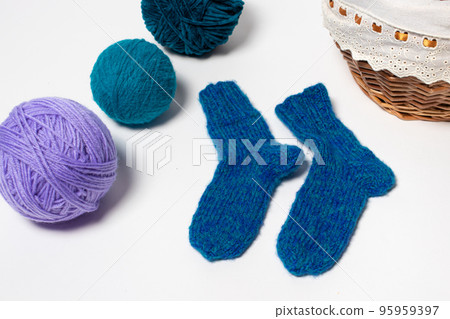 Blue knitted wool socks. Balls of multicolored yarn for knitting, handicrafts and hobbies 95959397
