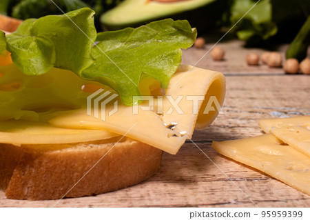 Appetizing simple sandwich with bread, cheese and lettuce. 95959399