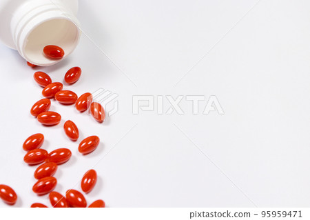 Orange capsules of lutein on a white background with place for text. Supplements and herbal medicine, homeopathy, treatment and prevention 95959471