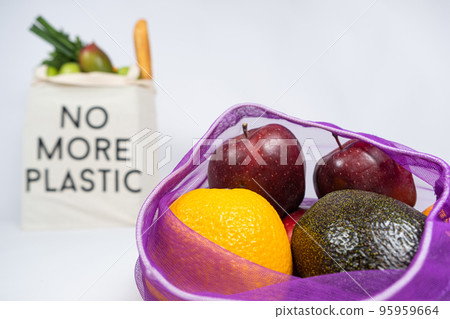 Fruit net and fabric bag with text no more plastic. Rejection of plastic bags. 95959664